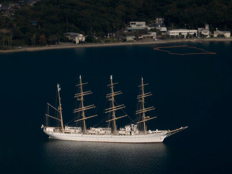A large white boat floating on top of a body of water